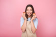 © LumenSt - Young woman in apron with cupcakes on a yellow background