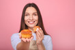 © LumenSt - Young woman in apron with cupcakes on a yellow background