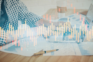 Multi exposure of stock market chart with man working on computer on background. Concept of financial analysis.