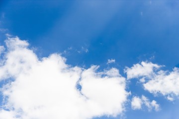 Wall Mural - Beautiful white big soft fluffy cloud on a clear blue sky background