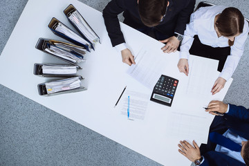 business people at meeting, view from above. bookkeeper or financial inspector making report, calcul