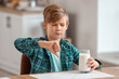 © Pixel-Shot - Little boy with dairy allergy in kitchen