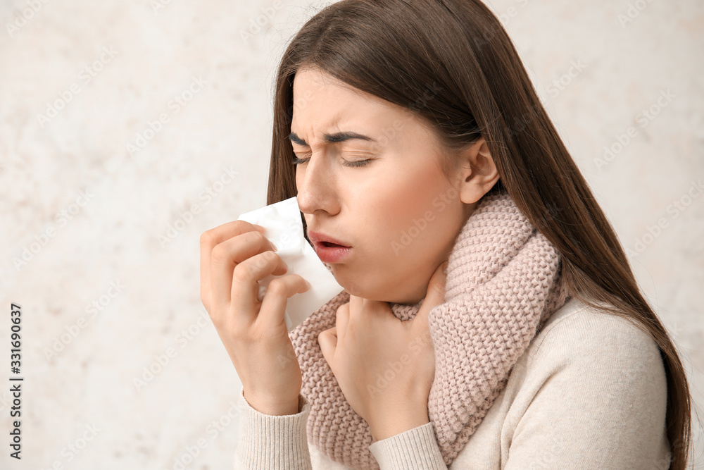 Coughing young woman on white background