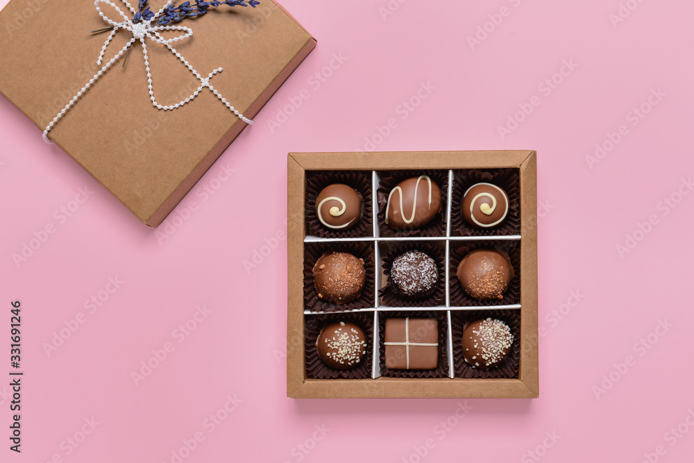 Box with delicious candies on color background