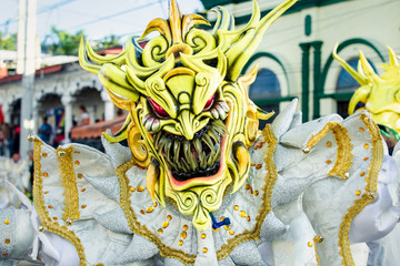 Wall Mural - closeup human in sparkling demon costume poses for photo at dominican carnival