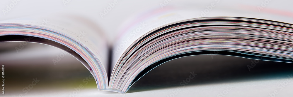 Colorful pages of an open magazine, close up. Selective focus. - obrazy, fototapety, plakaty 