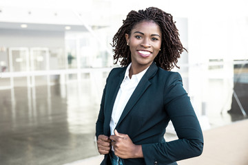 happy confident professional posing near office building. young african american business woman stan