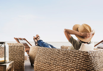 Young woman resting on terrace at home, Beautiful girl enjoying life, Vacations and summer fun concept