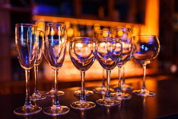 Many wine glasses on the bar with brilliance and light