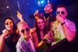 © standret - Young people sniffing drug in nightclub with colorful laser lights