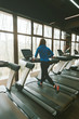 © Vulp - Photo of young sport woman running on treadmill in gym, morning sport time