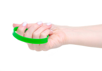 Wall Mural - Green rubber bracelet on hand on white background isolation