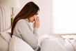 © New Africa - Sick young woman in bed at home. Influenza virus