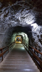 illuminated entrance to underground salt mine.