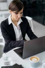 Businesswoman working on laptop in the cafe