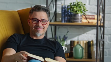 Stay at home - Older white man in glasses reading at home