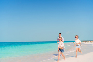 Happy beautiful family on a tropical beach vacation