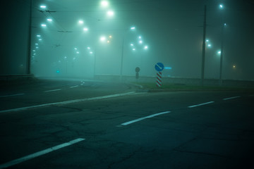 Highway road at night in the fog in the city