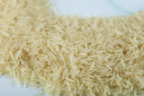 Fototapeta  - Dry and fresh asian rice on the blue marble