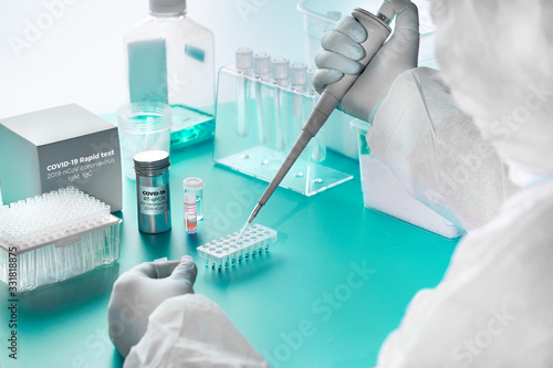 Novel coronavirus detection: pcr kit for detection of SARS-COV-2 novel coronavirus and rapid kit to detect antibodies for the virus in blood of recovered patients. Epidemiologist works in test lab.