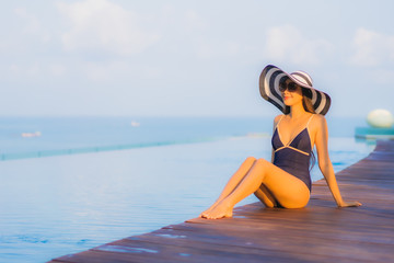 Portrait beautiful young asian woman relax around swimming pool in hotel resort