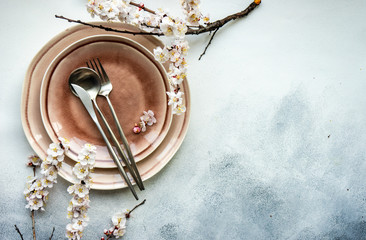 Minimalistic table setting with apricot blossom