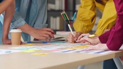 Canvas Print - Asian businessmen and businesswomen meeting brainstorming ideas about creative web design planning application and developing template layout for mobile phone project working together in small office.