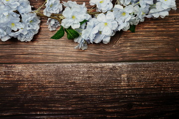 Sticker - Top view Blooming Flowers frame with copy space on wooden background