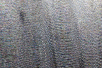 Close-up texture of flat steel surface manually cleaned with a flap wheel angle grinder.