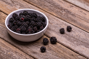 Wall Mural - Fresh blackberries in white ceramic bowl