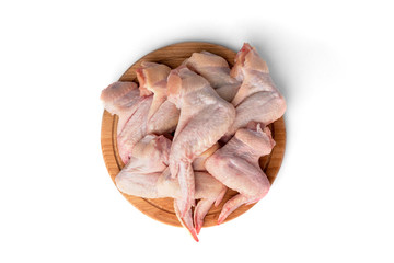 Wall Mural - Raw chicken wings on wooden board isolated on white background.