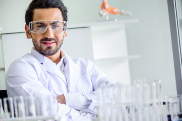 Wall Mural - attractive happiness scientist man lab technician assistant analyzing sample in test tube at laborat