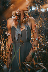 close up portrait of young and tender woman on a feild at sunset