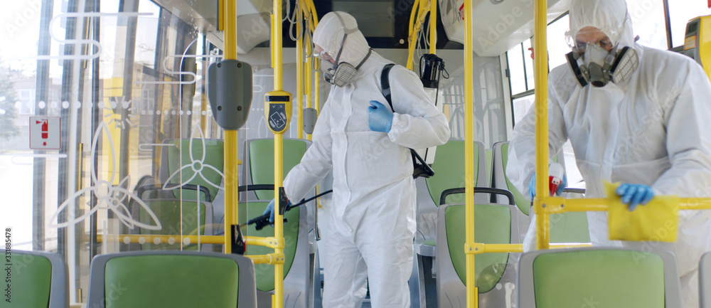 HazMat team in protective suits decontaminating public transport, bus interior during virus outbreak - obrazy, fototapety, plakaty 