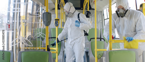 Fotomural HazMat team in protective suits decontaminating public transport, bus interior d