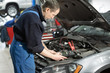 © smishura - Mechanic examining under hood of car at the repair garage Car service mechanic repairing and maintenance Car. auto mechanic man or smith with wrench at workshop