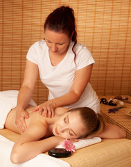 Wall Mural - Beautiful young woman having a massage treatment in spa salon - wellness