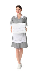 Sticker - Young chambermaid holding stack of fresh towels on white background