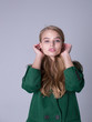 © Grustock - An image of an attractive, elegant blonde standing in a green coat