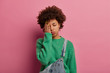 © wayhome.studio - Photo of tired Afro American woman makes facepalm, covers face with hand, sighs from tiredness, feels embarrassed and exhausted after exam preparation, tired in early morning, poses on pink wall