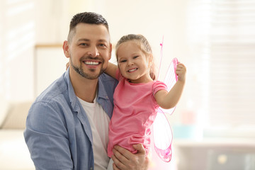 Canvas Print - Father playing with his child at home