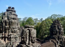 Ruins Of Angkor, Face Tower Of Bayon Temple Against Blue Sky, Angkor Wat, Cambodia