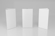 © Kakabe - Promotional table talker isolated on white background, mockup template paper tri-fold vertical triangle cards with reflections. white sheets front & left and right view. 3d render