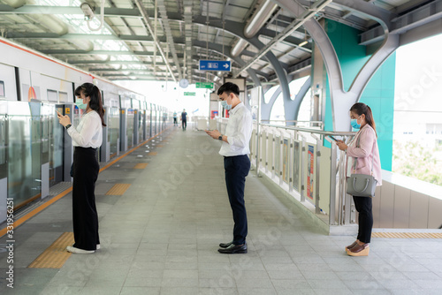 Three Asian people wearing mask standing distance of 1 meter from other people keep distance protect from COVID-19 viruses and people social distancing  for infection risk