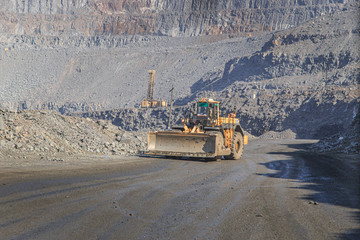 Wall Mural - Wheel dozer rides on the road in a quarry