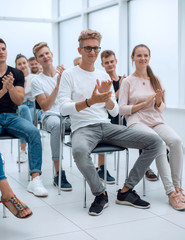 Wall Mural - group of young people applaud at a group meeting