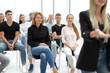 © ASDF - group of diverse young people sitting in a conference room