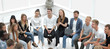 © ASDF - large group of diverse young people sitting in a circle
