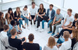 © ASDF - large group of diverse young people sitting in a circle