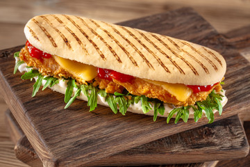 Wall Mural - panini sandwich with crispy chicken and rucola salad